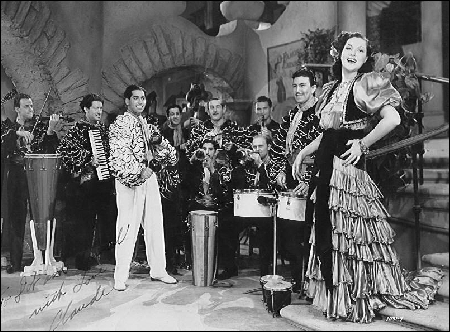 Claude appears playing his accordion in this 1939 motion picture musical An Old Spanish Custom, later renamed In Rhumba Land, featuring the Darryl Harpa Orchestra and celebrated singer, Wini Shaw. &nbsp;(Released through Universal Studios. Still searching for a film copy, please help.)